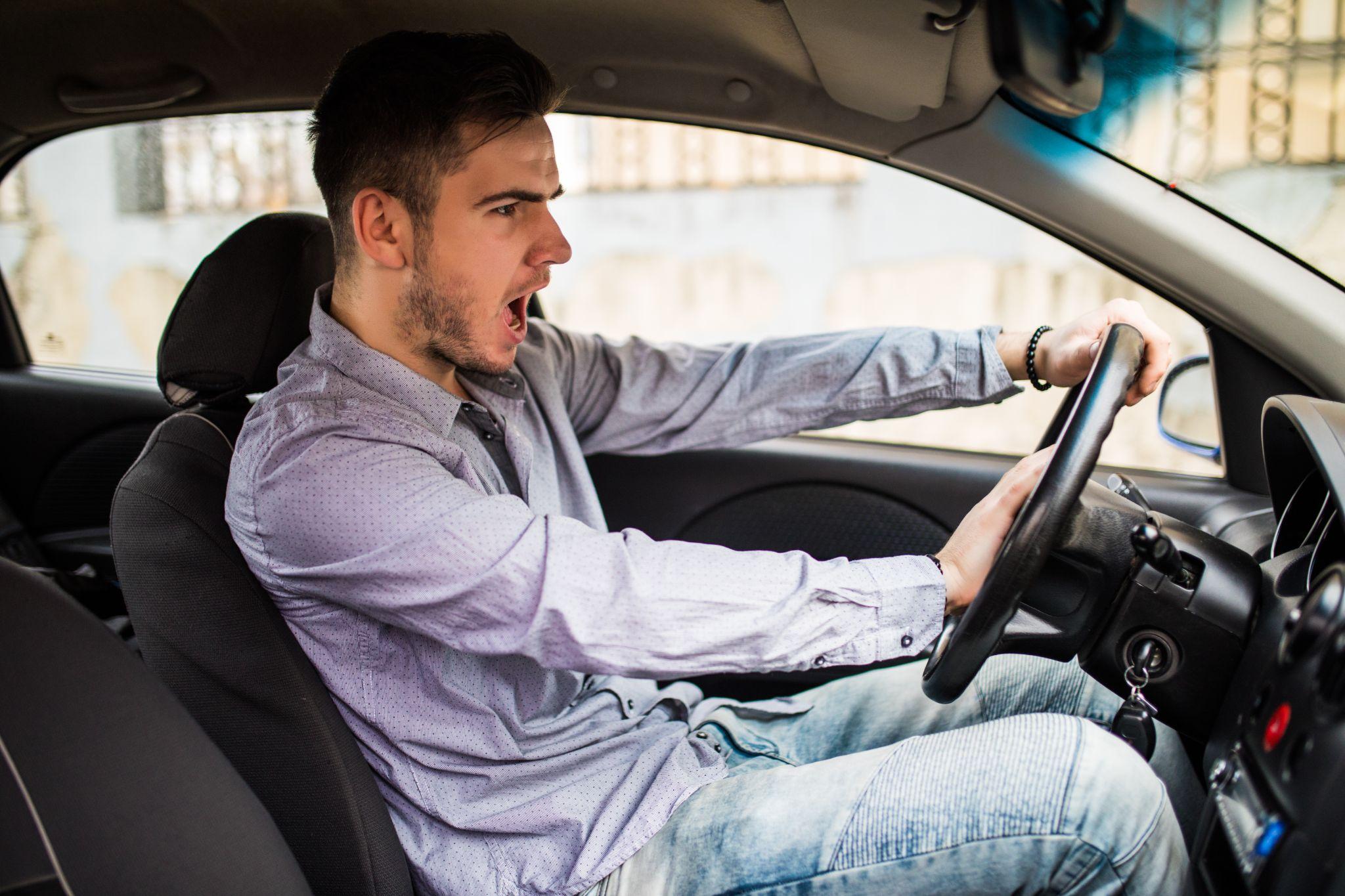 Driving instructor teaching student proper vehicle operation techniques