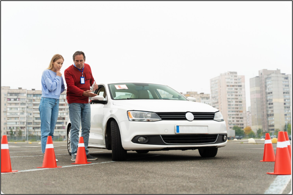 Instructor pointing at clipboard for student during driving lesson.